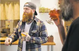  ??  ?? Co-founder Alex Tweet chats with friends while sipping beer during a special can release Saturday at Fieldwork Brewing Co. in Berkeley.