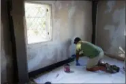  ?? SARAH COLE VIA AP ?? A specialty craftsman repairs plaster on the walls at the James Blake House in Boston. The house is one of the oldest structures in Boston and dates back to 1661.