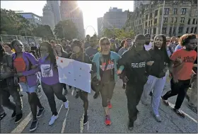  ?? AP/St. Louis Post-Dispatch/CRISTINA M. FLETES ?? State Rep. Bruce Franks Jr. (third from right) leads a silent march Monday on Market Street in St. Louis.