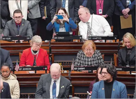  ?? SARAH GORDON/THE DAY ?? State Rep. Christine Conley, D-Groton, takes a photo as Rep. John Hampton, D-Simsbury, looks on during the opening of the Connecticu­t General Assembly session for 2020 on Wednesday at the State Capitol in Hartford.