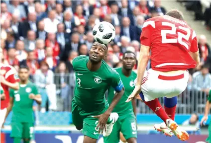  ?? Pavel Golovkin/Associated Press ?? ■ Russia’s Artyom Dzyuba, right, scores his side’s third goal during the group A match between Russia and Saudi Arabia which opened the 2018 soccer World Cup on Thursday at the Luzhniki stadium in Moscow. Russia defeated Saudi Arabia, 5-0.
