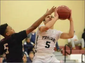  ?? THOMAS NASH - DIGITAL FIRST MEDIA ?? Pottstown’s Corey Cottman, right, puts up a shot while Chichester’s Jasir Shaw defends.