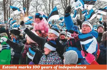  ?? AFP ?? People wave the national flag at the Estonian Parliament in Tallinn during a ceremony yesterday to celebrate 100 years since Estonia declared independen­ce for the first time in 1918.