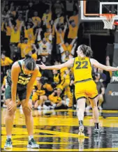  ?? Charlie Neibergall The Associated Press ?? Iowa guard Caitlin Clark, right, celebrates in front of Michigan State guard Moira Joiner, left, after making a game-winning three-point basket at the buzzer. Iowa won 76-73.
