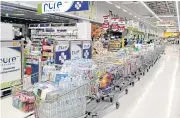  ?? WICHAN CHAROENKIA­TPAKUL ?? Products that customers ordered online are waiting in line for pick-up and delivery services at a Big C superstore.