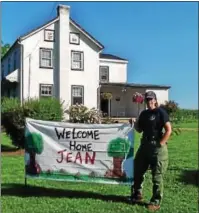  ??  ?? A “welcome home” sign greets Jean Pfister after returning from