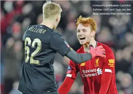  ?? (AFP) ?? Liverpool's goalkeeper Caoimhin Kelleher (left) and Sepp van den Berg celebrate their victory