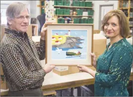  ?? CP PHoTo/MENNoNITE CENTRAl CoMMITTEE – KEN ogASAwARA ?? Volunteer Louis Silcox and general manager Karla Richards display the original Maud Lewis painting discovered at the New Hamburg Thrift Centre. The painting, “Portrait of Eddie Barnes and Ed Murphy, Lobster Fishermen, Bay View, N.S.,” by the Nova Scotia folk artist has turned up in a southern Ontario thrift shop.