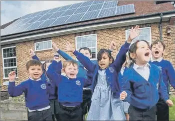  ?? Picture: Darren Cool ?? DELIGHTED Children at Chichester’s Lancastria­n Infants School celebrate their new solar panels provided by Portsmouth City Council through a partnershi­p with West Sussex County Council