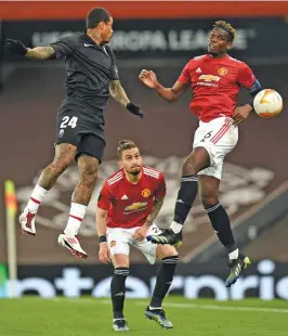  ?? AFP ?? Manchester United’s Alex Telles looks on as his teammate Paul Pogba (right) vies with Granada’s Kenedy (left) during their UEFA Europa League quarterfin­al second leg match at Old Trafford stadium in Manchester on Thursday. —