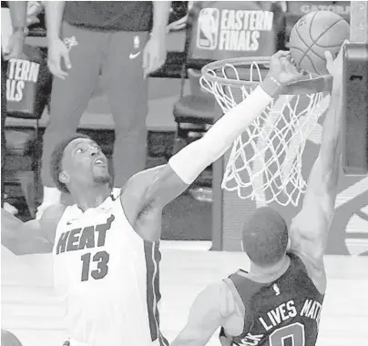  ?? MARKJ.TERRILL/AP ?? This block by Bam Adebayo against the Celtics’Jayson Tatum preserved the Heat’s Game 1 victory in the East finals.