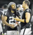  ?? Ben Margot ?? The Associated Press Raiders running back Marshawn
Lynch (24) talks on the sideline with quarterbac­k Derek Carr during their NFL preseason game Saturday against the Los Angeles Rams.