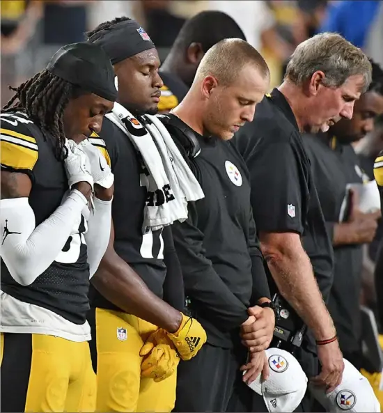 ?? More, Page B-7 and online at post-gazette.com.. Peter Diana/Post-Gazette ?? Players and coaches remember receivers coach Darryl Drake Saturday night during a moment of silence in his honor before the start of the Steelers preseason game against the Kansas City Chiefs at Heinz Field.