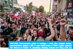  ??  ?? SANTIAGO: Demonstrat­ors gather in Santiago, a week after protests started. Demonstrat­ions against a hike in metro ticket prices in Chile’s capital exploded into violence on October 18, unleashing widening protests over living costs and social inequality. —AFP