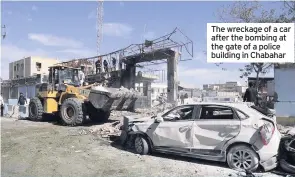  ??  ?? The wreckage of a car after the bombing at the gate of a police building in Chabahar