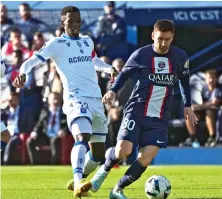  ?? AP ?? PSG’s Lionel Messi, right, and Auxerre’s Birama Toure in action during the French League One soccer match between Paris Saint Germain and Auxerre.