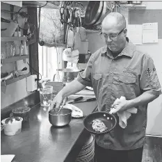  ?? RICHARD MARJAN ?? Chef Chad Forrest cooks up dishes with Louisiana Creole flavours in his kitchen at the Little Red Market Cafe in Mortlach.