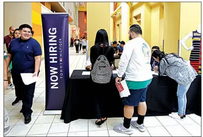  ?? AP/ALAN DIAZ ?? Job seekers gather at a job fair booth on Oct. 3 in the Dolphin Mall in Sweetwater, Fla. August job openings fell slightly to just under 6.1 million, the Labor Department said Wednesday, from 6.14 million in the previous month.