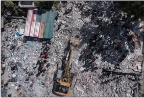  ?? (AP/Matias Delacroix) ?? A bulldozer works Monday at the site of the collapsed Hotel Le Manguier in Les Cayes, Haiti, two days after a 7.2 magnitude earthquake struck the southweste­rn part of the country.