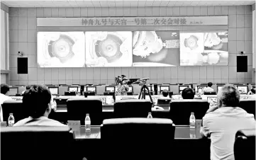  ??  ?? File photo shows Chinese technician­s at the Jiuquan Space Centre monitor the Shenzhou-9 spacecraft as it prepares to link with the Tiangong-1 module just over a week into a manned space mission which includes China’s first female astronaut, following an automatic docking. — AFP photo