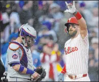  ?? Matt Slocum The Associated Press ?? Bryce Harper crosses home plate in front of Mets catcher Tomas Nido after hitting a home run in the Phillies’ 10-5 win Wednesday night.