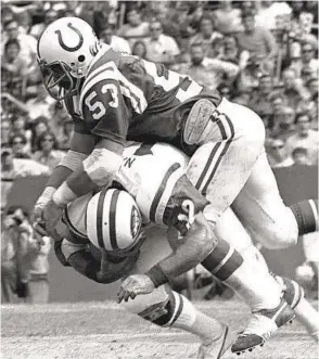  ?? AP FILE ?? New York Jets quarterbac­k Joe Namath is slammed to the ground by Baltimore Colts linebacker Stan White in a game in 1973. Namath separated his shoulder on the play.