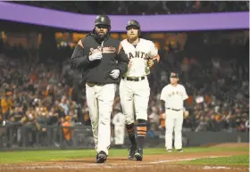  ?? Thearon W. Henderson / Getty Images ?? Johnny Cueto is nearly passed by Hunter Pence after Pence homered with Cueto aboard in the fifth. It gave the Giants a 3-2 lead over Colorado.