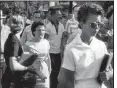  ?? Democrat Gazette file photo/WILL COUNTS ?? Hazel Bryan
shouts insults at Elizabeth Eckford as she walks past a line of National Guardsman.