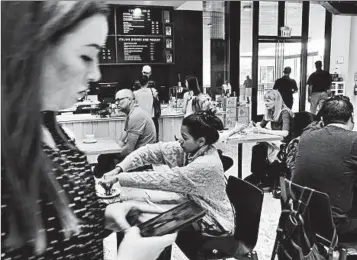  ?? RICHARD VOGEL/AP ?? Customers dine at a Los Angeles mall that features a 15-screen movie theater, a grocery store, fitness clubs and a clinic.