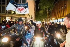  ??  ?? Unexpected feat: Eintracht Frankfurt fans celebratin­g their team’s German Cup victory over Bayern Munich in Frankfurt on Saturday. — AFP