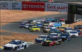  ?? SEAN GARDNER / GETTY IMAGES ?? Pole sitter Kyle Larson (42) leads the field around an early turn Sunday during the Monster Energy Cup Series race at Sonoma (Calif.) Raceway.