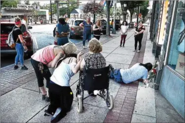  ?? TOM KELLY — FOR DIGITAL FIRST MEDIA ?? Friends of High Street murder victim Diamonde Stone pray and cry on the sidewalk near where he fell after being stabbed to death July 30, during a vigil for him Aug. 1.