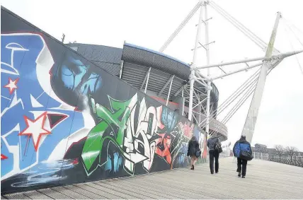  ?? Andrew James ?? > Street art on Millennium walkway alongside the Principali­ty Stadium in Cardiff