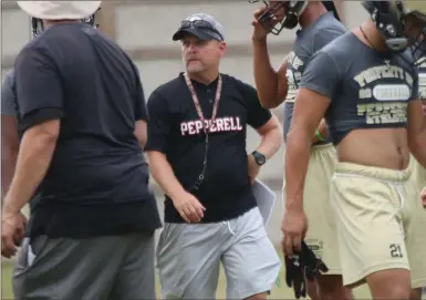  ?? Blaylock / Jonathan ?? Pepperell head football coach Rick Hurst watches his team run drills during a practice session Monday in Lindale.