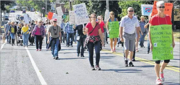  ??  ?? People marched in the streets, carrying signs aimed at sending messages that the current situation is unacceptab­le.