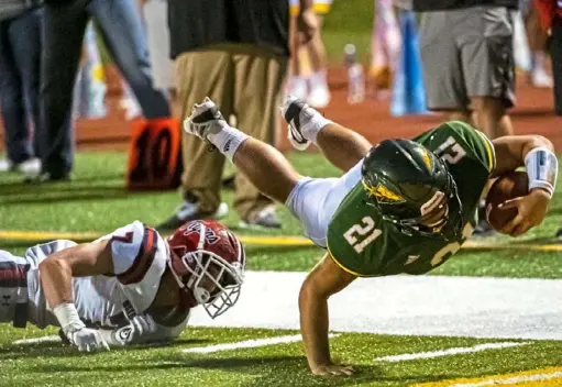  ?? Michael M. Santiago/Post-Gazette ?? David LaRotonda, defensive back for McKeesport, left, watches as Sam Fanelli, running back for Penn-Trafford, falls just short of a touchdown Friday night at Penn-Trafford High School.