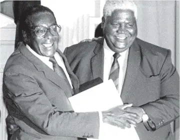  ?? ?? Former President the late Cde Robert Mugabe and the late Dr Joshua Nkomo embrace after signing of the Unity Accord