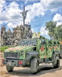  ??  ?? A multi-purpose armored vehicle of the elite Special Action Force patrols the downtown area of Cebu City yesterday. ALDO NELBERT BANAYNAL