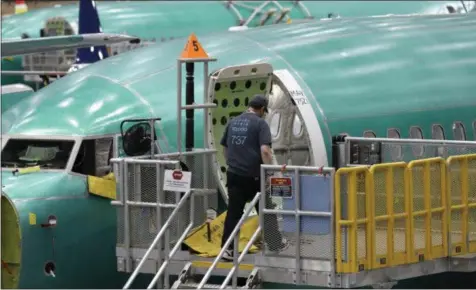  ?? TED S. WARREN - ASSOCIATED PRESS ?? This March 27file photo shows a Boeing 737MAX 8airplane on the assembly line during a brief media tour of Boeing’s 737assembl­y facility in Renton, Wash. Recent crashes have caused an uptick in airline fatalities in 2018and 2019after a long trend of safer flying. Boeing 737Max accidents have raised concern over the ability of all pilots to handle automation. Still, aviation deaths are down sharply from the 1990s, and experts credit advances in aircraft and airport design, better air traffic control, and more pilot training.