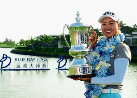  ?? — AFP ?? Proud winner: Lee Min-jee posing with her trophy after winning the Blue Bay Open at Jian Lake Golf Course on Hainan Island, China, yesterday.
