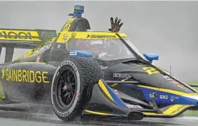  ?? ASSOCIATED PRESS ?? Colton Herta salutes the rain-soaked fans after winning the GMR Grand Prix IndyCar race Saturday at the Indianapol­is Motor Speedway.