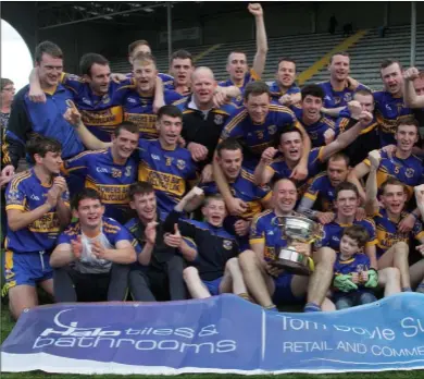  ??  ?? Gusserane veteran Philip Wallace proudly holds the Wexford Creamery Cup as the celebratio­ns kick in after Sunday’