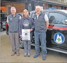  ??  ?? Kate Sampson of the Arran Rangers presents members of the Arran Mountain Rescue Team with a cheque for £1,800 from the Goatfell Torchlight Challenge. Photo Corinna Goeckeritz