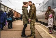  ?? DANIEL BEREHULAK/NYT ?? A Ukrainian solder and his wife say goodbye in March as their 5-year-old daughter looks on at the train station in Kramatorsk, Ukraine. They traveled 10 days to meet him.