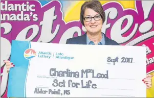  ?? CHRISTIAN ROACH/CAPE BRETON POST ?? Charlina MacLeod is seen with a cheque from Atlantic Lottery’s Set for Life at the Emera Centre Northside in North Sydney on Friday. MacLeod, from Alder Point, chose a lump sum of $675,000 as her prize instead of $1,000 a week for 25 years.