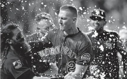  ?? David Zalubowski, The Associated Press file ?? Colorado’s Charlie Blackmon, left, congratula­tes Ryan Mcmahon for his three-run, walk-off home run vs. the Dodgers on Aug. 11, 2018. Mcmahon hit five homers and batted .232 in 91 games with the Rockies.