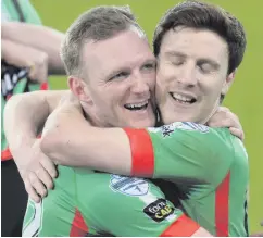  ??  ?? Hug of delight: Stephen Gordon and Willie Garrett celebrate after Glentoran’s comeback victory