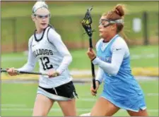  ?? KYLE FRANKO — TRENTONIAN PHOTO ?? Notre Dame’s Ava Scudillo (4) carries the ball while being defended by Hopewell Valley’s Maddie Schrader (12) during Wednesday’s game.