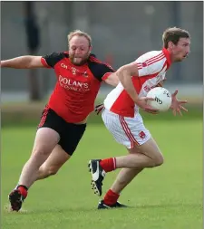  ??  ?? Coolkenno’s Ben Jackman tries to stop the run of Tinahely’s Brian Walsh during the IFC clash in Joule Park Aughrim.