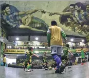  ?? JUAN MABROMATA / AFP ?? Kids play indoor soccer at the Sportivo Pereyra de Barracas club in Buenos Aires, which features Lionel Messi and Diego Maradona painted into a unique version of Michelange­lo's ‘Creation of Adam’ on the ceiling.